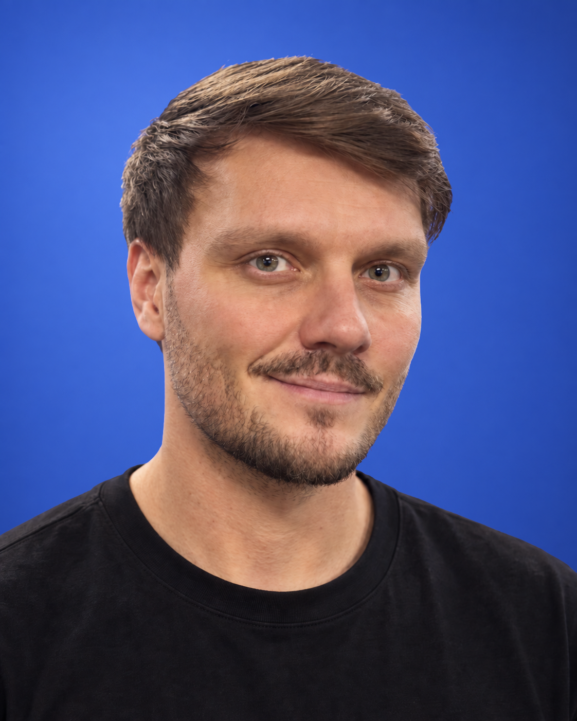 Seva Latin in a dark crew-neck shirt against a blue background